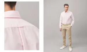 Uomo con abito blu e camicia rosa, un look elegante e moderno.
