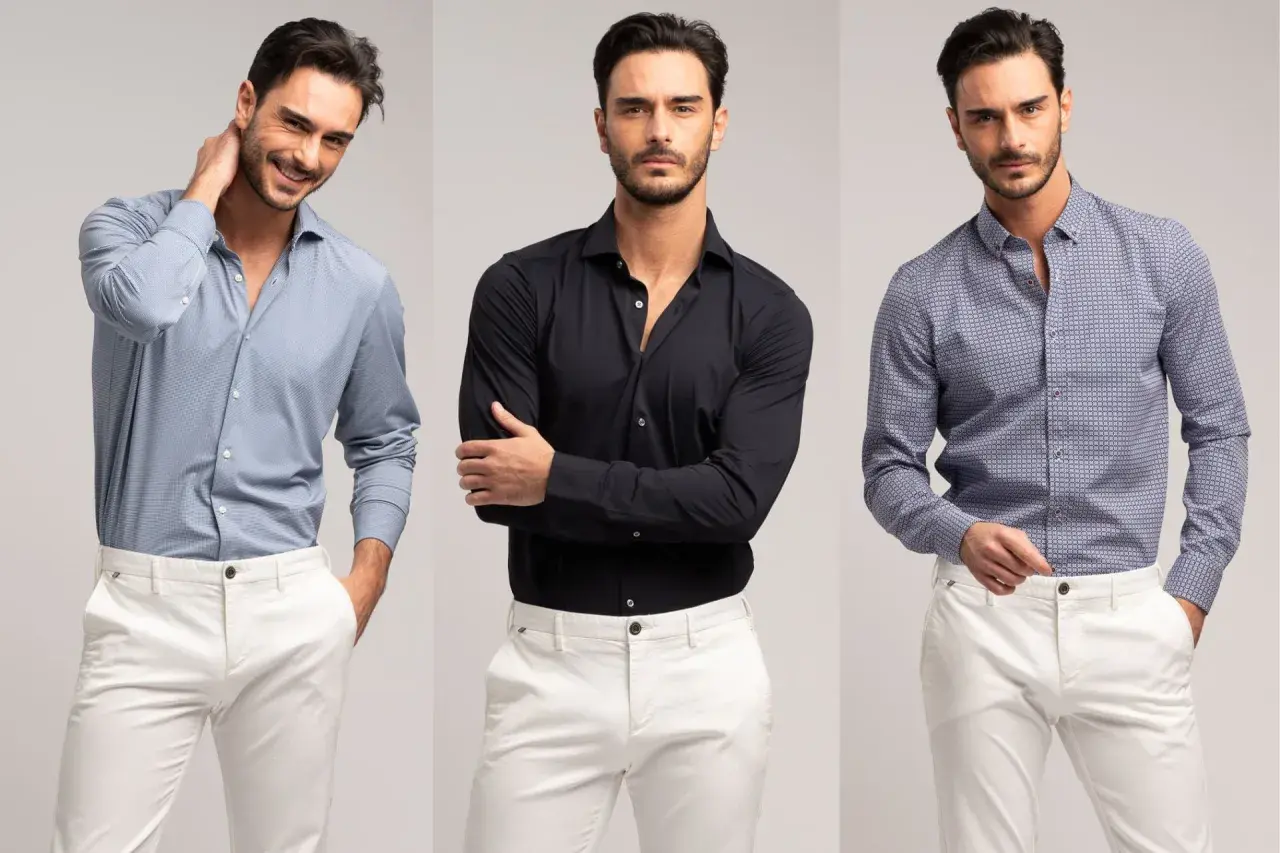 Uomo con camicie da uomo particolari: azzurra microfantasia, nera tinta unita e blu con fantasia geometrica, abbinate a pantaloni bianchi.