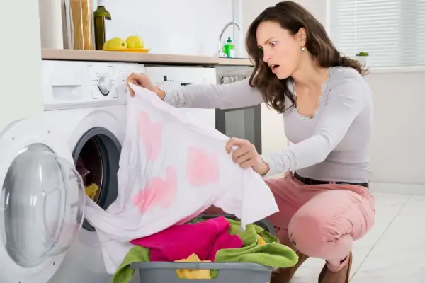 Donna sorpresa scopre macchie scure sui vestiti dopo lavaggio in lavatrice. Come toglierle?