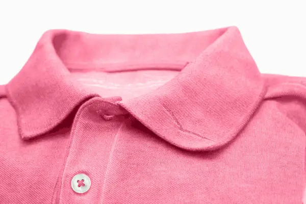 Collo di una camicia polo rosa. Scopri come lavare le camicie a mano per mantenerle perfette.