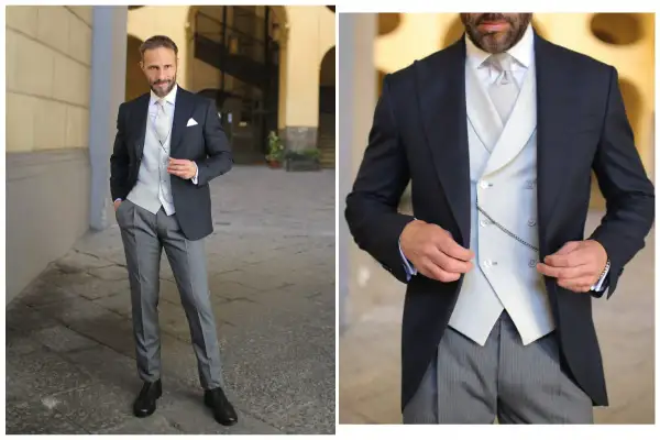 Uomo elegante in spezzato con cravatta, gilet e catenella da orologio.